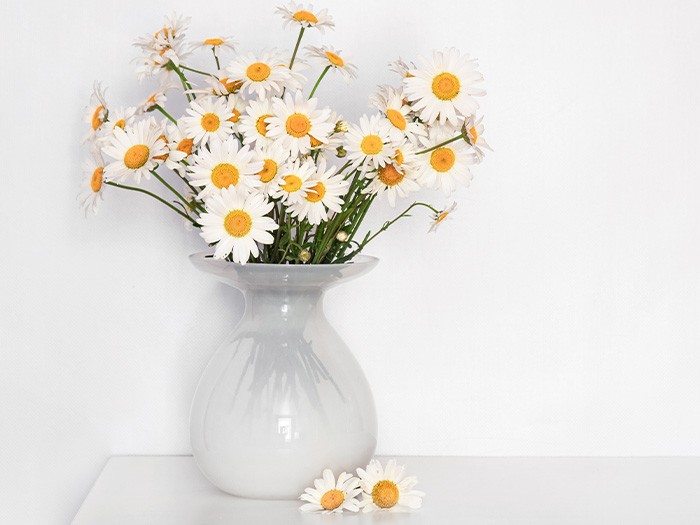 An hourglass vase is the perfect home for round blooms. 